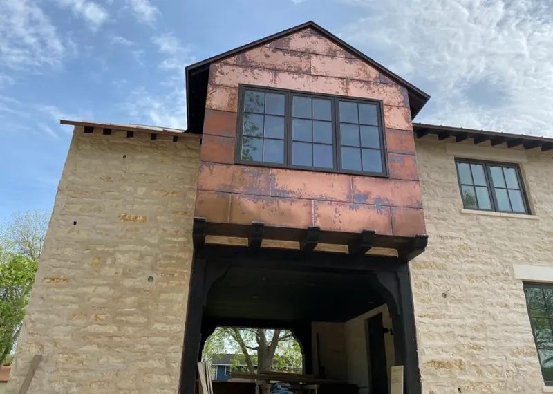 Copper metal panel facade on a stone building for Skylight Installation in Wellston